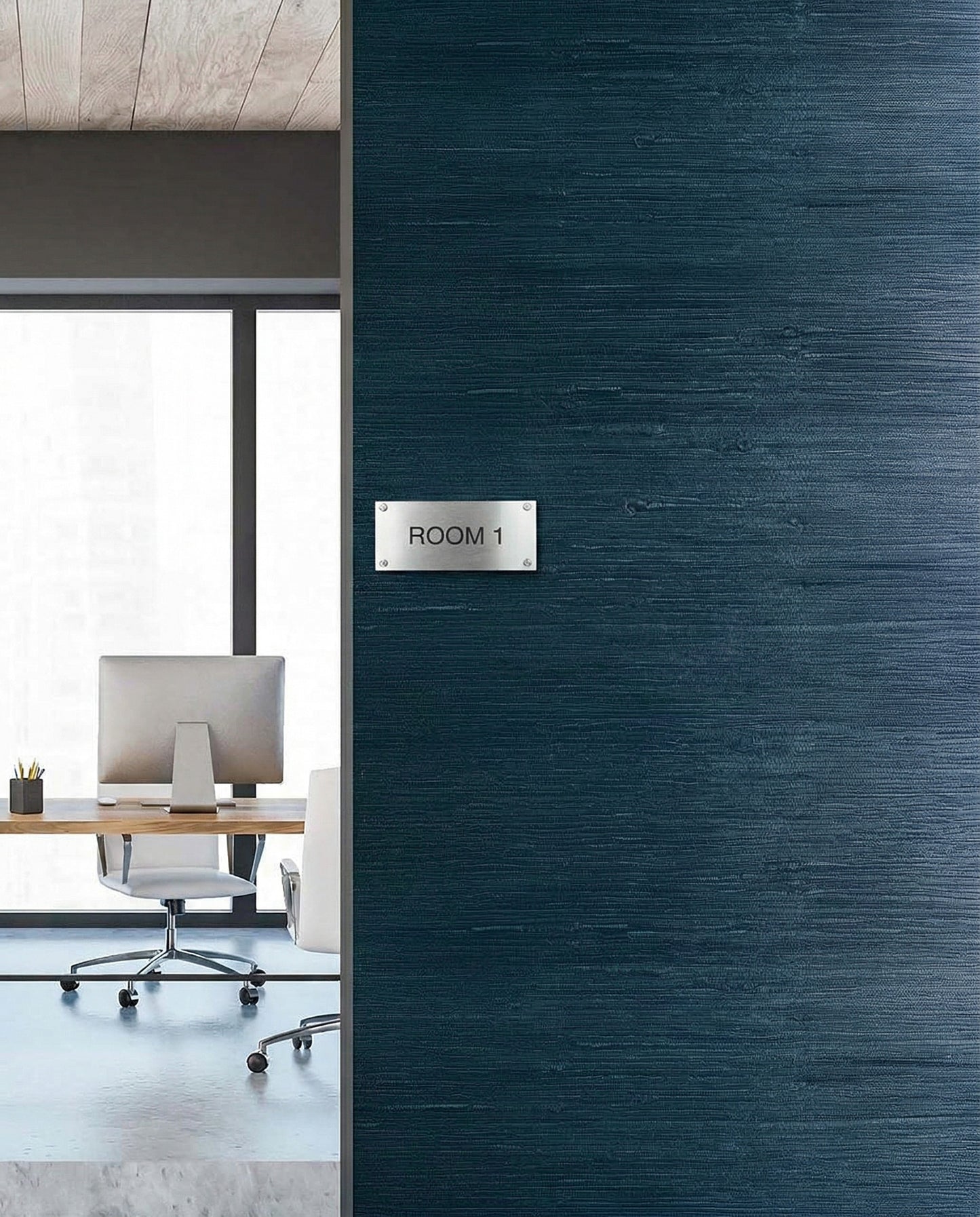 Modern office with desk and chair seen through doorway, featuring Straw Texture Grasscloth Naturals wall decor.