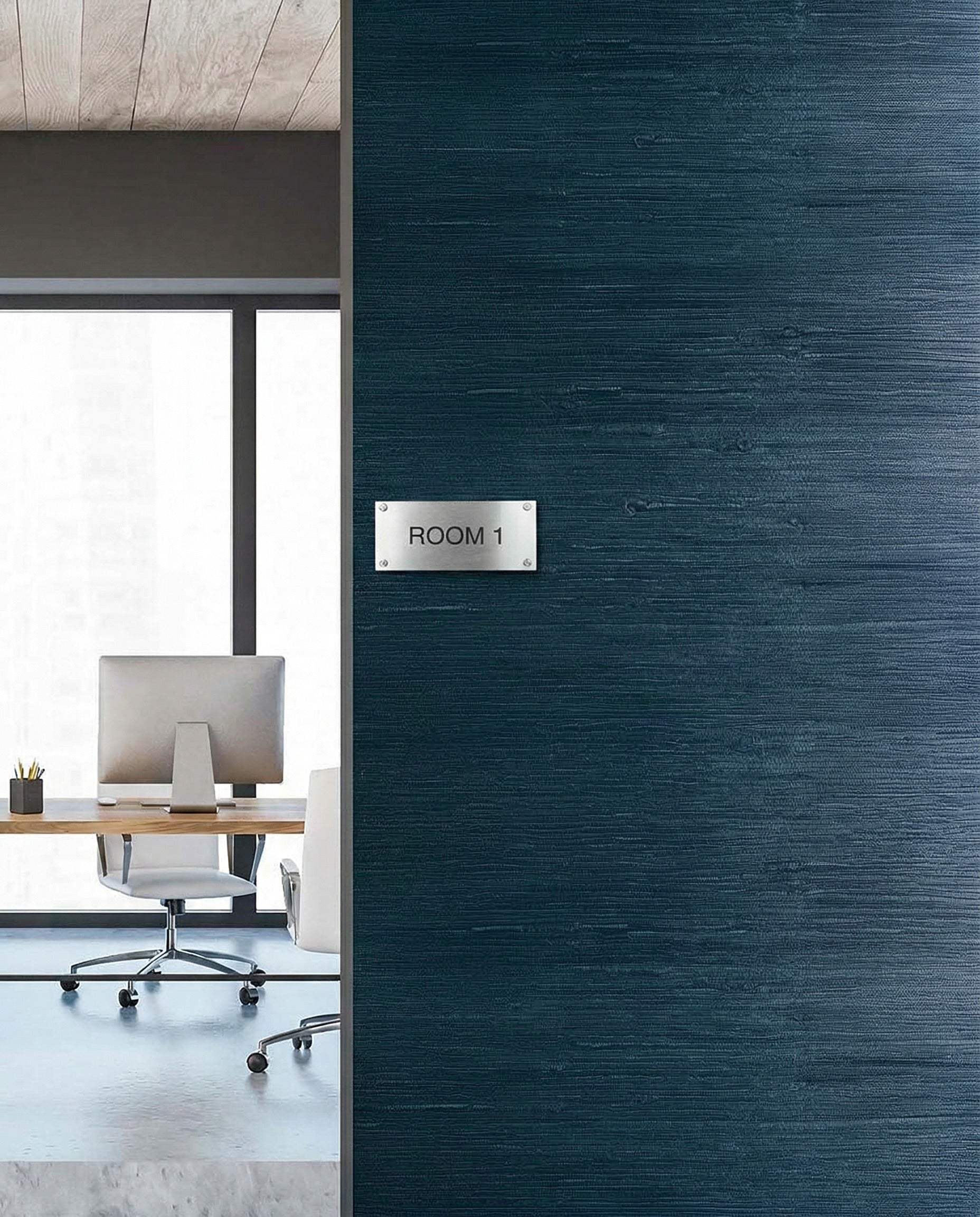 Modern office with desk and chair seen through doorway, featuring Straw Texture Grasscloth Naturals wall decor.