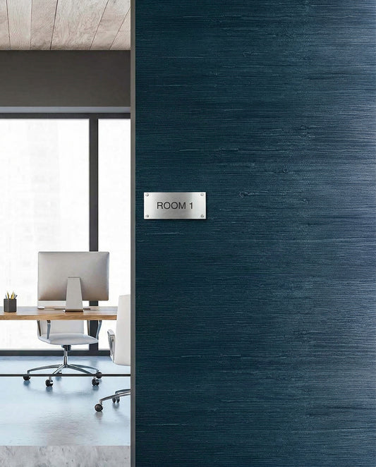 Modern office with desk and chair seen through doorway, featuring Straw Texture Grasscloth Naturals wall decor.