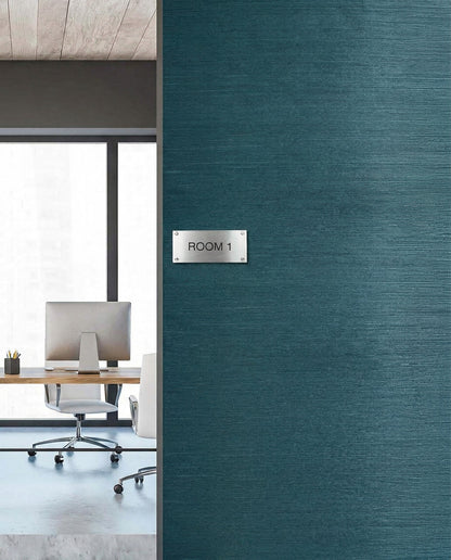 Modern office with desk and chair seen through door labeled Room 1, featuring Sisal Texture Grasscloth Naturals.