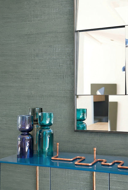Modern decor featuring Straw Texture Grasscloth Naturals, glass vases, a blue table, and copper accents.