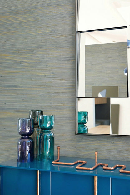 Straw Texture Grasscloth pairs with blue glass vases, a glossy cabinet, wall decor, and a modern mirror.