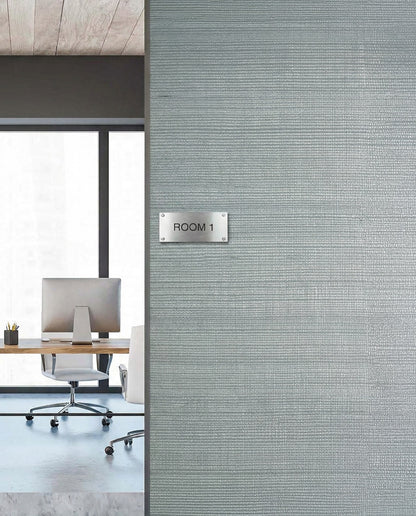 Modern office with a desk and chair, featuring Sisal Texture Grasscloth Naturals wallpaper on a textured gray wall.
