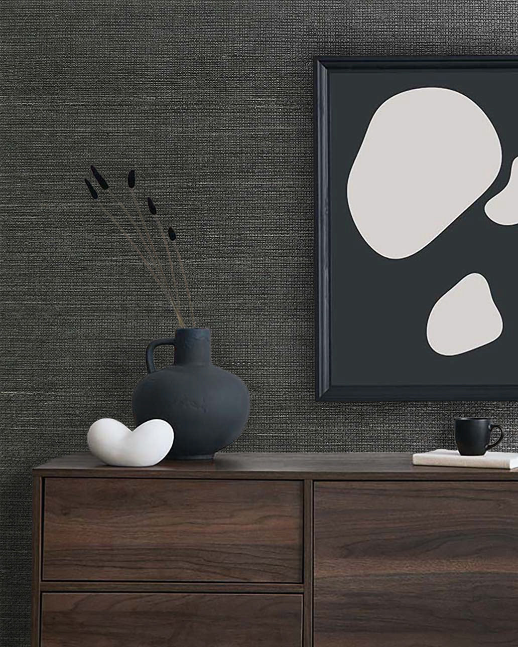 Minimalist decor with abstract art and a dark vase on a dresser, set against Sisal Texture Grasscloth Naturals wallpaper.
