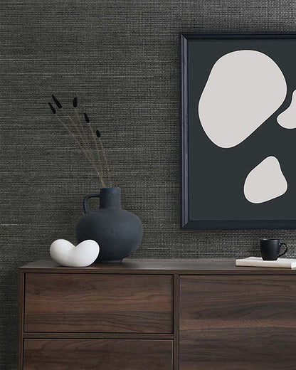 Minimalist decor with abstract art and a dark vase on a dresser, set against Sisal Texture Grasscloth Naturals wallpaper.