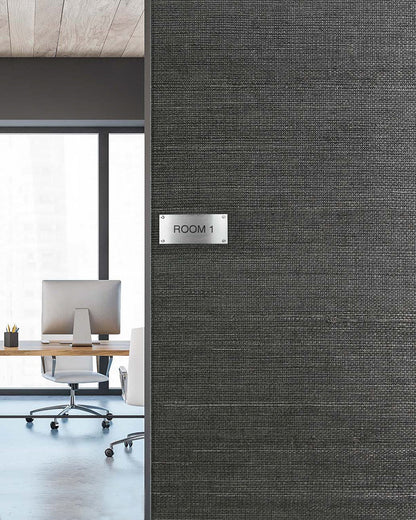 Office with two desks and chairs; ROOM 1 sign on Sisal Texture Grasscloth Naturals wall by large city-view windows.