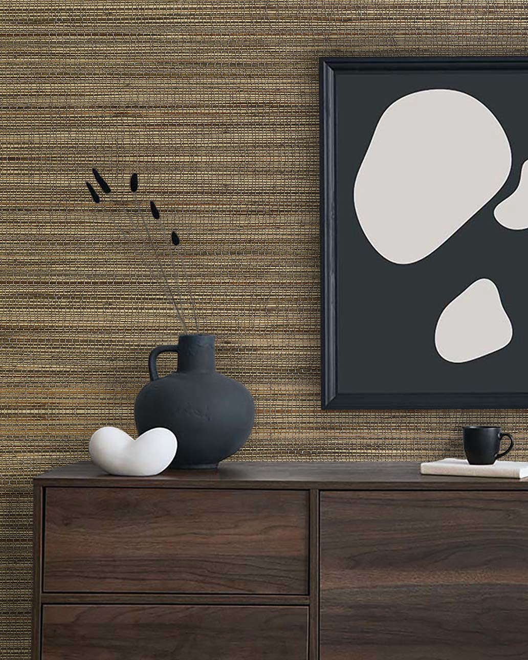 Minimalist decor with a dark vase, abstract art, and cup on a dresser against Straw Texture Grasscloth Naturals.