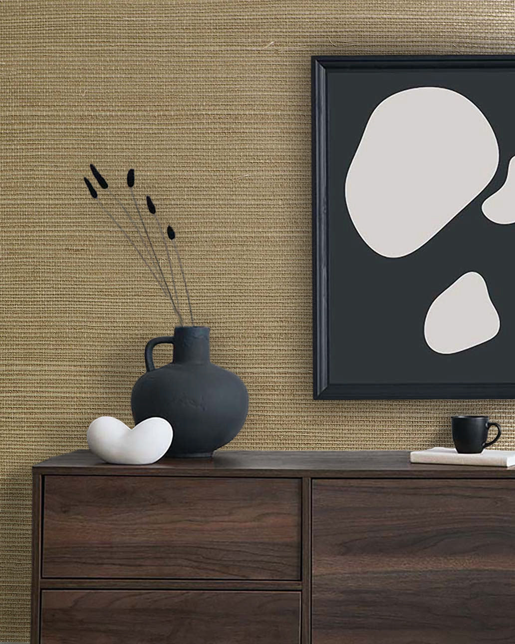 Minimalist decor with a black vase, white sculpture, and abstract art on a dresser against Sisal Texture Grasscloth wallpaper.