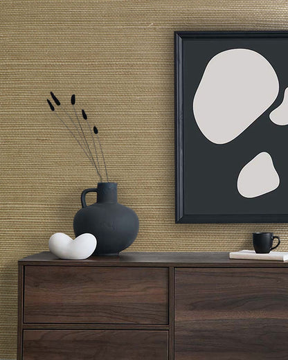Minimalist decor with a black vase, white sculpture, and abstract art on a dresser against Sisal Texture Grasscloth wallpaper.