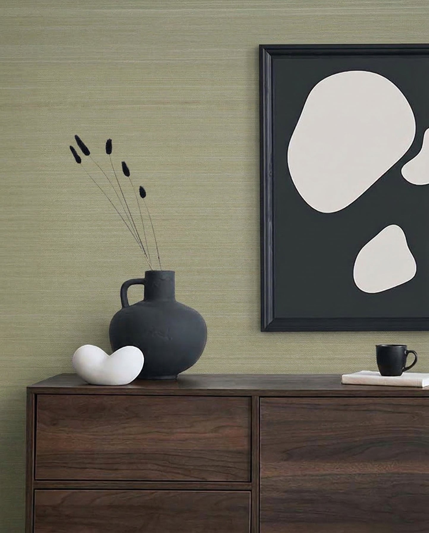 Minimalist decor with a dark vase, abstract art, and white sculpture on a cabinet against Silk Fabric Grasscloth Naturals.