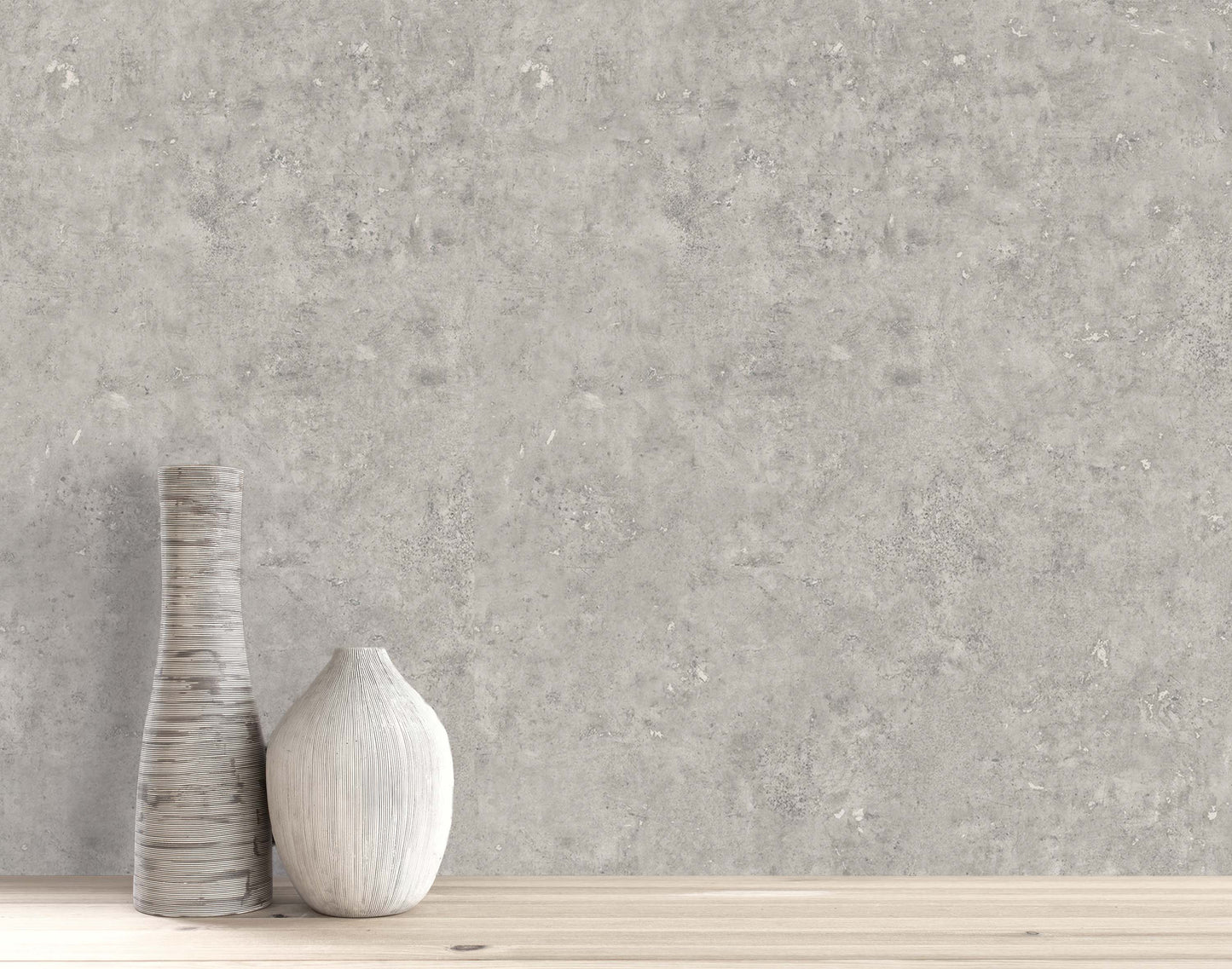 Two ceramic vases on wood in front of Cement Commercial Vinyl, a modern wallcovering with a concrete look.