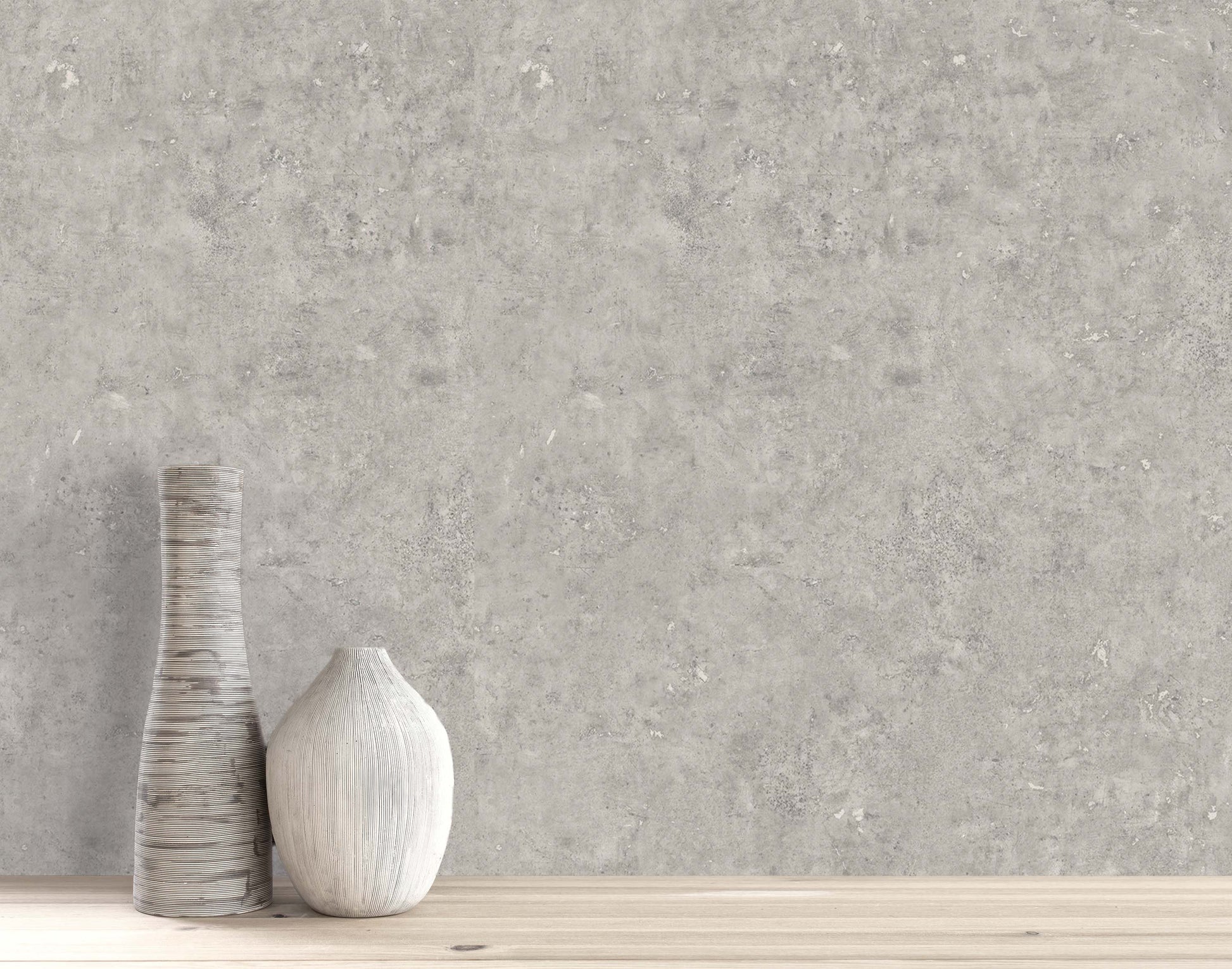 Two ceramic vases on wood in front of Cement Commercial Vinyl, a modern wallcovering with a concrete look.