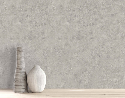 Two ceramic vases on wood in front of Cement Commercial Vinyl, a modern wallcovering with a concrete look.