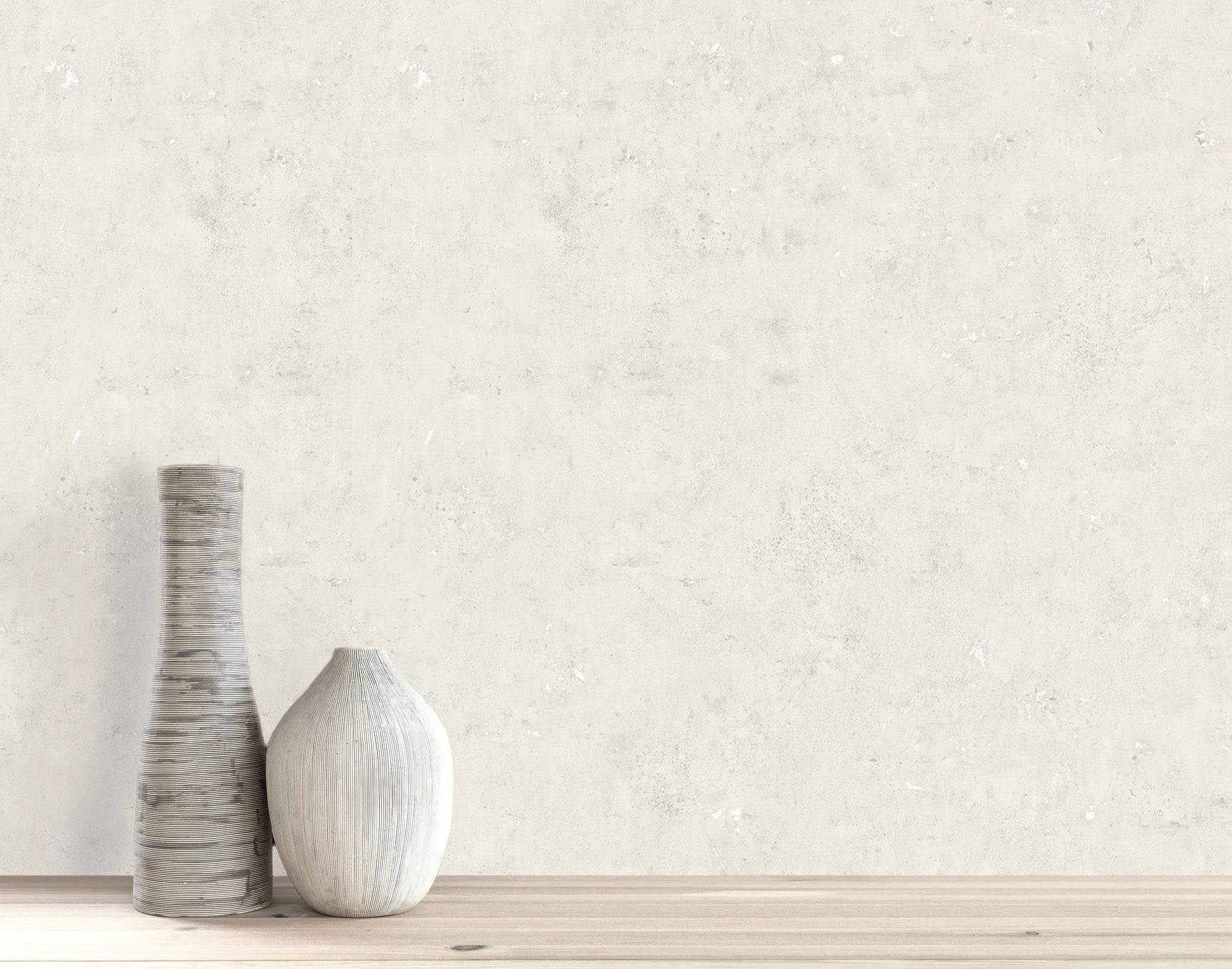 Two decorative vases on wood with Cement Commercial Vinyl faux unpasted wallpaper as a light, textured backdrop.
