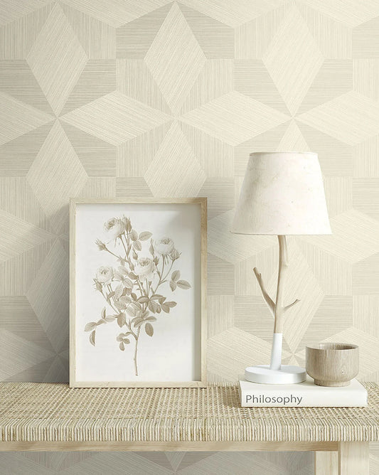 A framed rose drawing, lamp, cup, and book on a woven table against Texture Parquet Commercial Vinyl wallpaper.