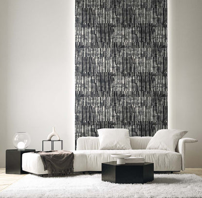 Modern living room with a white sectional, black tables, abstract wall art, and Abstract Vertical Stripes Wallpaper.