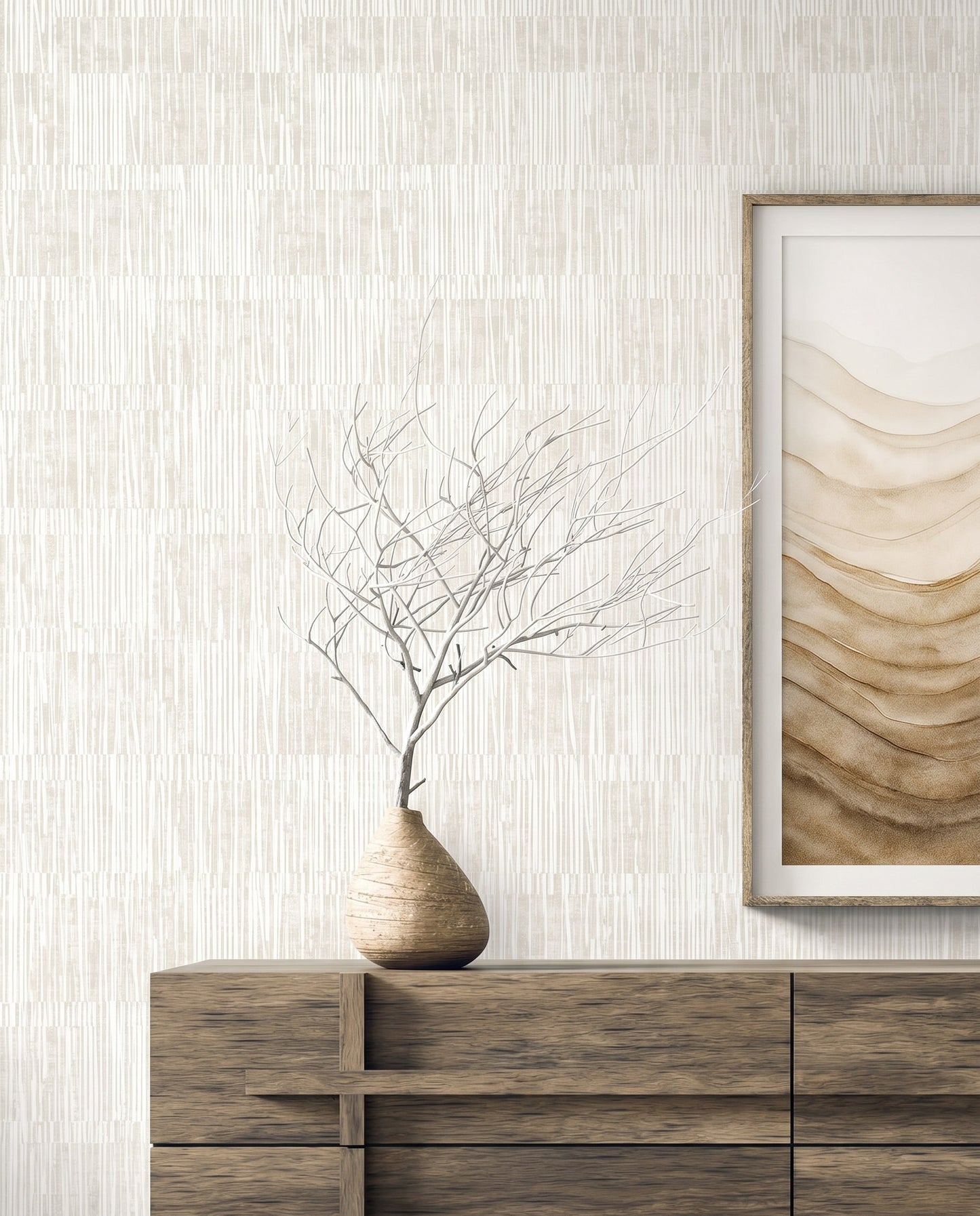 A wooden dresser with a vase and art sits before Abstract Vertical Stripes Wallpaper in textured beige tones.