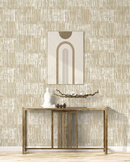 Minimalist console table with decor and art set against Abstract Vertical Stripes Wallpaper in beige tones.