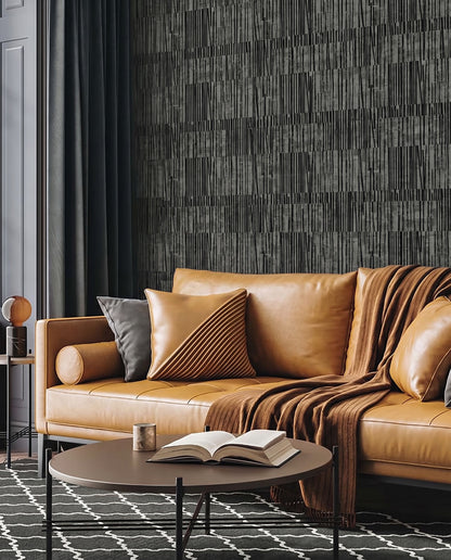 Tan leather sofa with cushions, round coffee table, and Abstract Vertical Stripes Wallpaper in a modern living room.