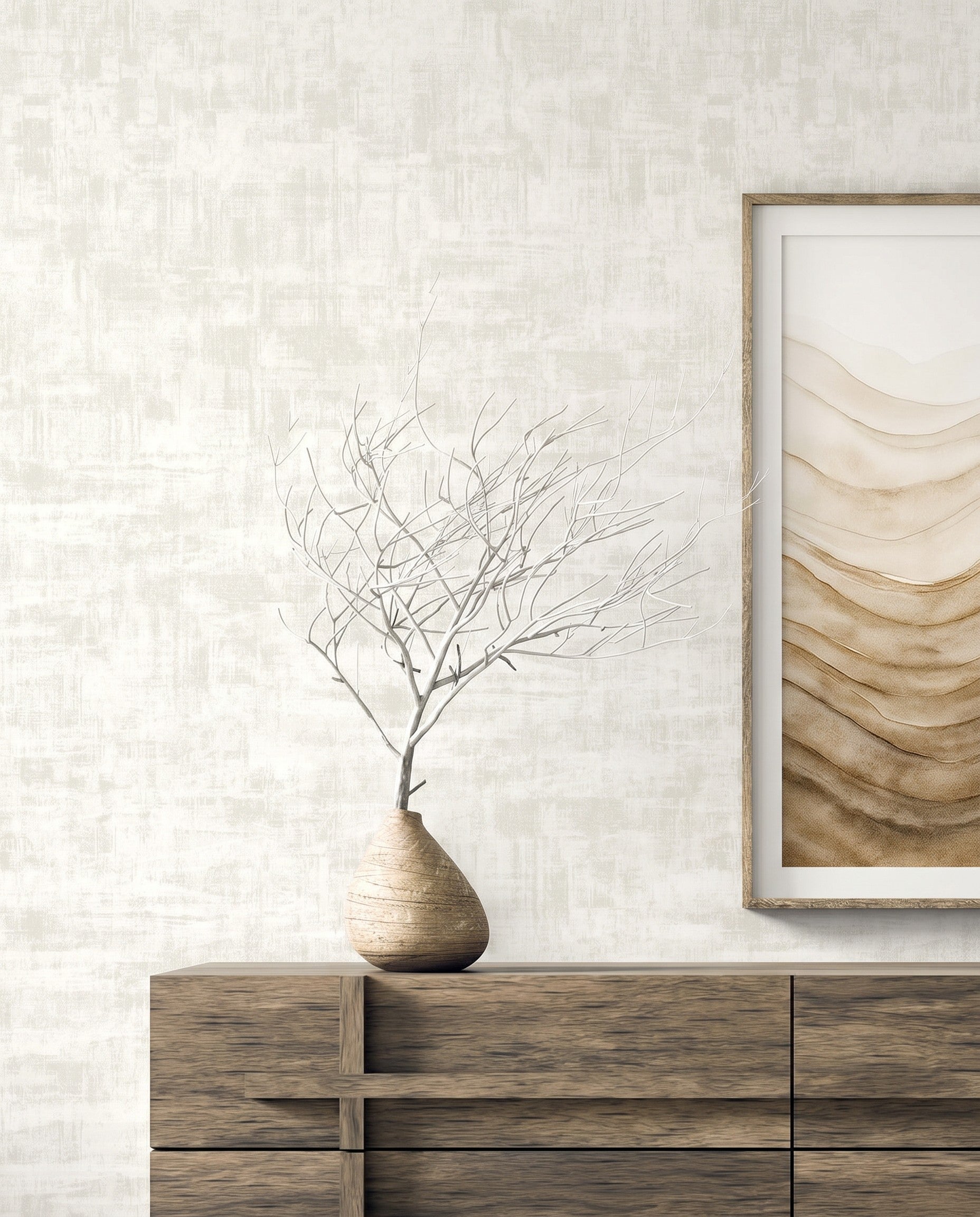 Minimalist interior with a wooden dresser, bare branches, abstract art, and Distressed Faux Wallpaper on the wall.