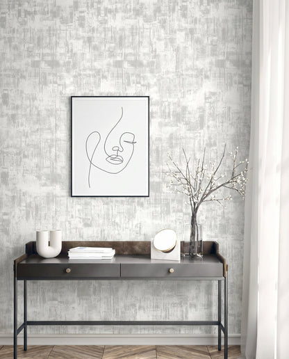Minimalist console table with vases, mirror, and books under line art on Distressed Faux Wallpaper in textured gray.