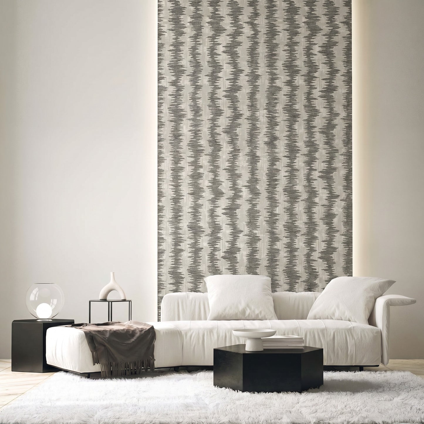 Modern living room with a white sofa, black tables, Ikat Stripe Wallpaper, neutral decor, and a shag rug.