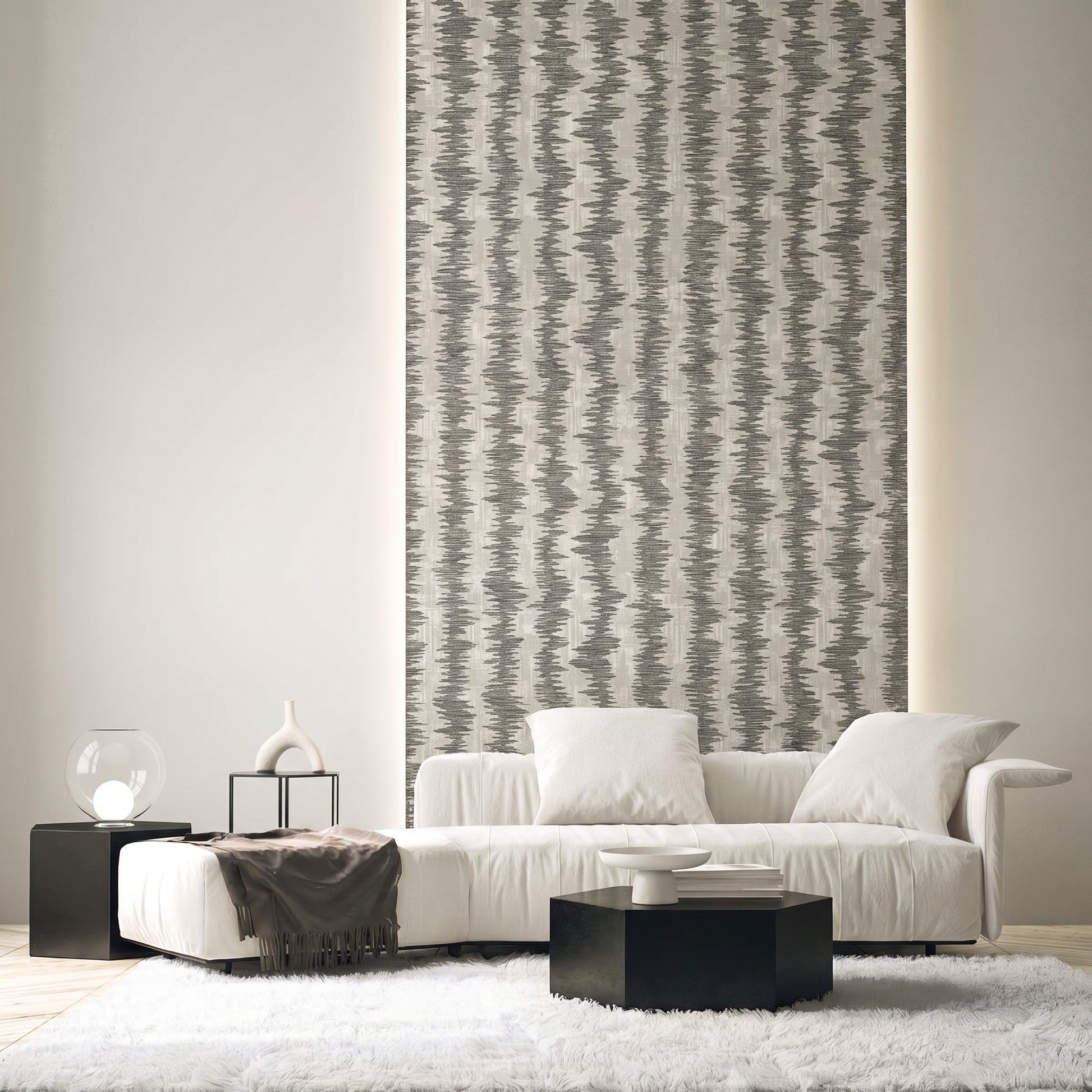 Modern living room with a white sofa, black tables, Ikat Stripe Wallpaper, neutral decor, and a shag rug.