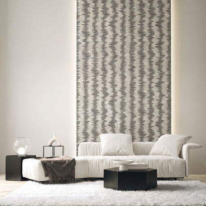 Modern living room with a white sofa, black tables, Ikat Stripe Wallpaper, neutral decor, and a shag rug.