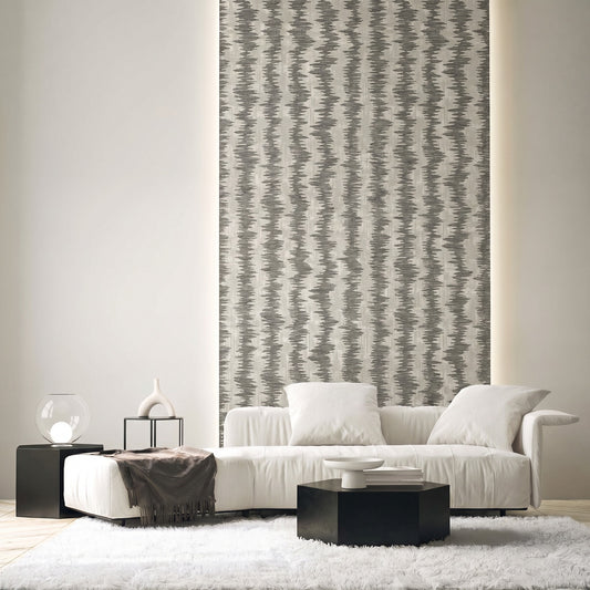 Modern living room with a white sofa, black tables, Ikat Stripe Wallpaper, neutral decor, and a shag rug.