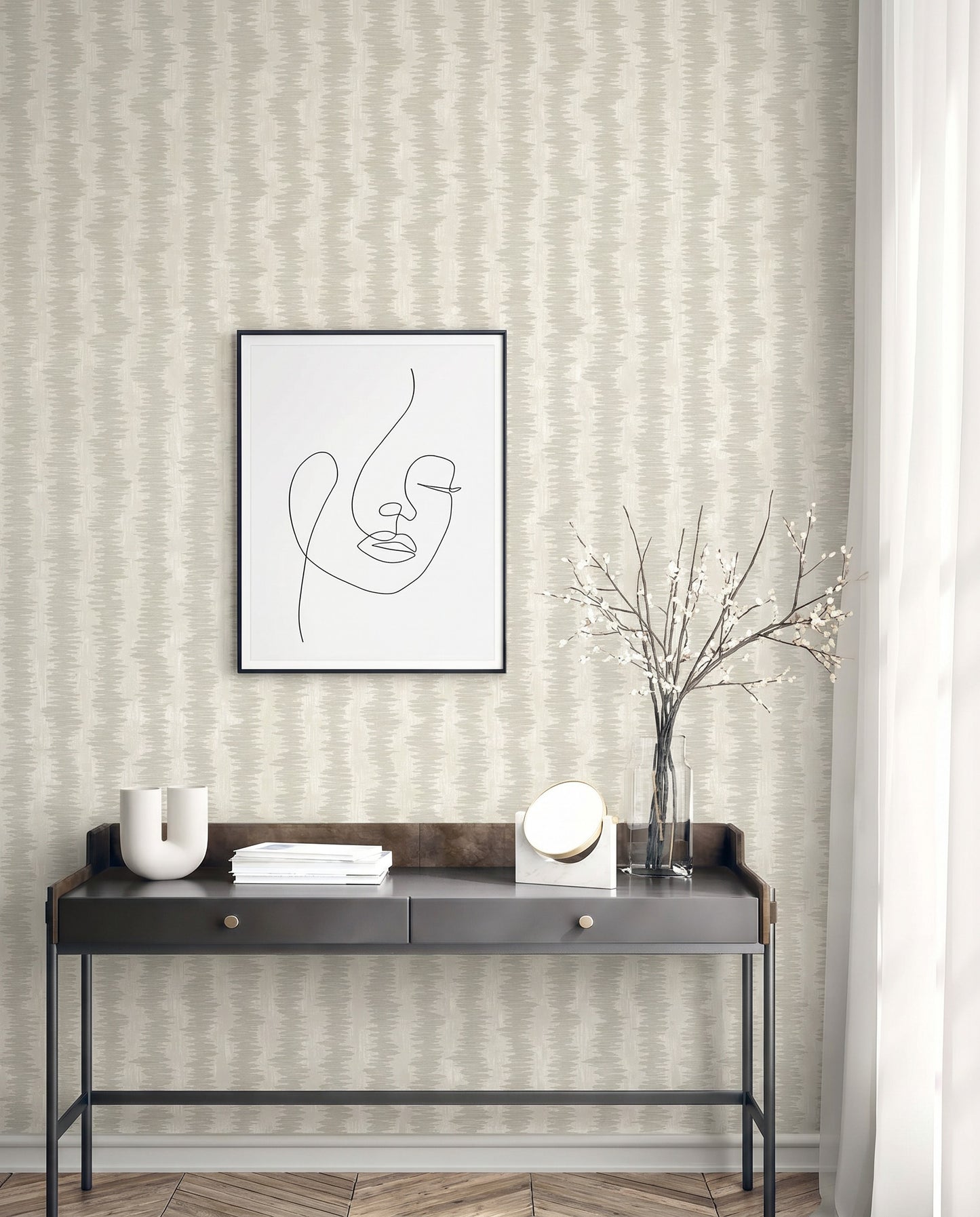 Minimalist console table with decor, abstract line art, vase with branches, and Ikat Stripe Wallpaper on the wall.