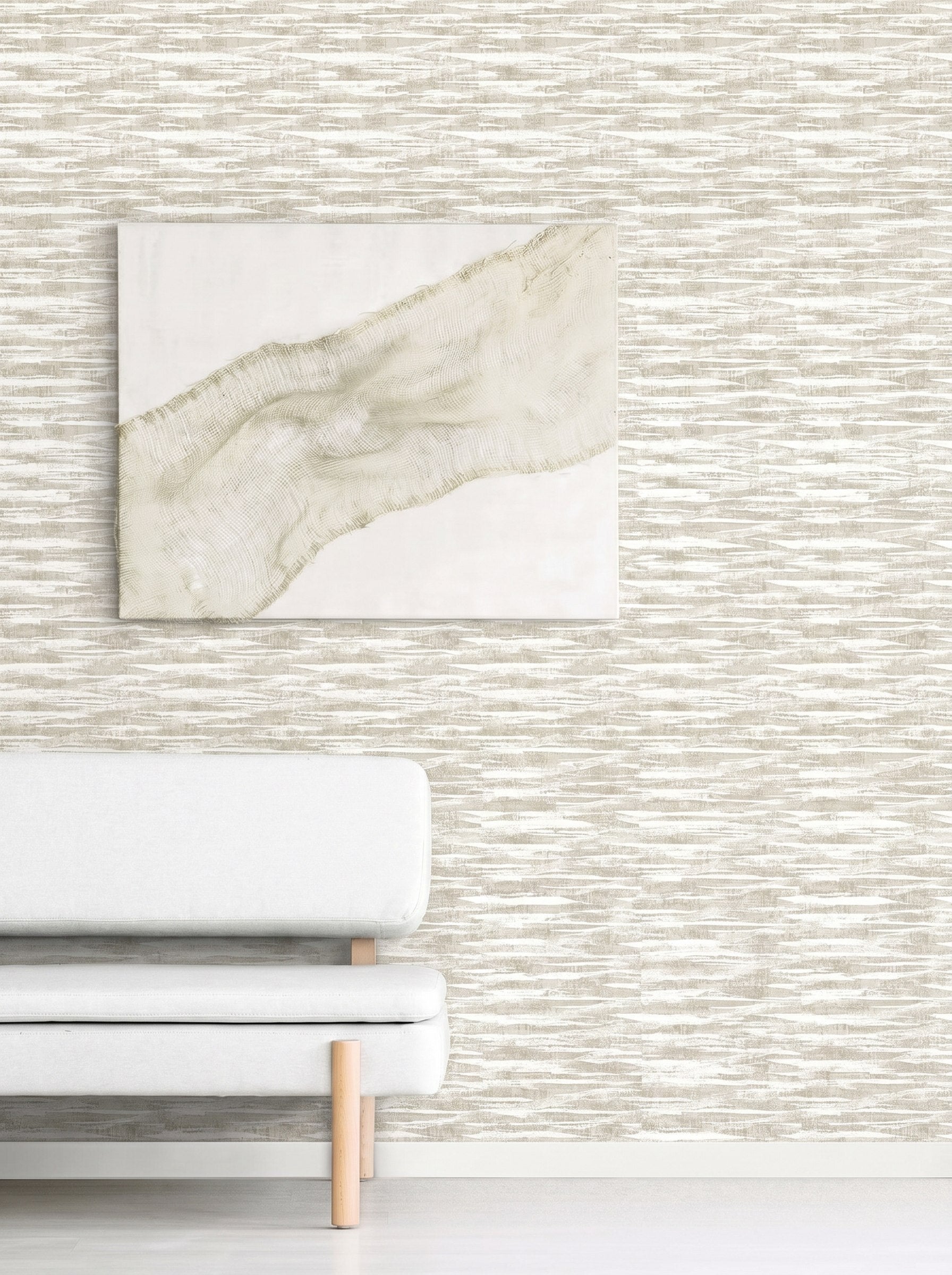 Minimalist living room with a light grey sofa and abstract art on Stone Nebulite Wallpaper in beige and white patterns.