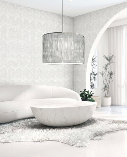 Modern living room with a white curved sofa, round marble coffee table, and Chevron Wallpaper for easy maintenance.