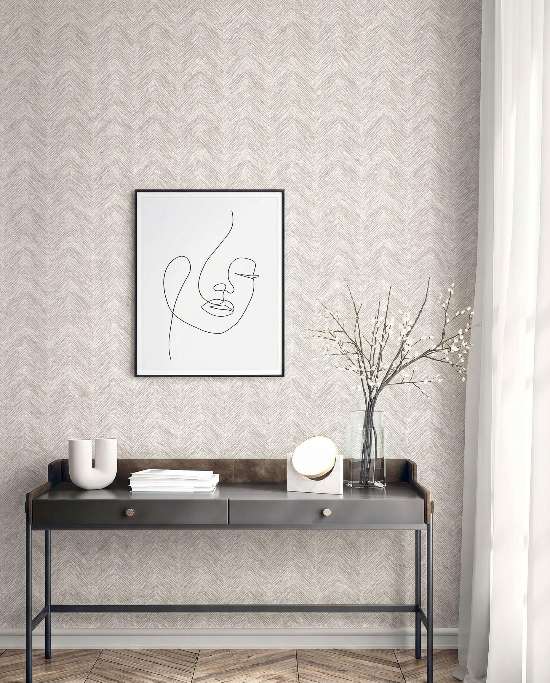 Modern console table with decor under minimalist art on Chevron Wallpaper in beige, washable and patterned, by a window.