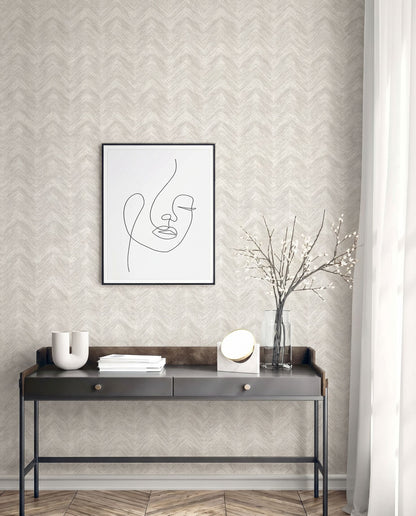 Modern console table with decor under minimalist art on Chevron Wallpaper in beige, washable and patterned, by a window.