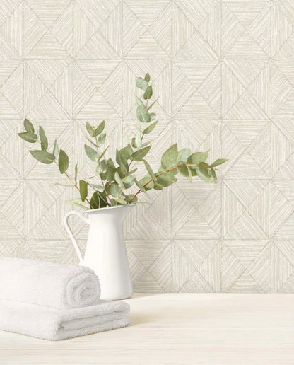 White pitcher with eucalyptus and towels sits by a wall with Inlay Tile Wallpaper in a geometric pattern.