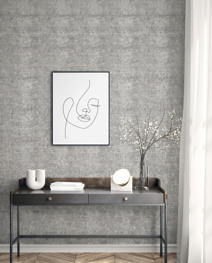 Minimalist entryway with a black console table, abstract line art, Dotted Wallpaper, white vase, books, and branches.