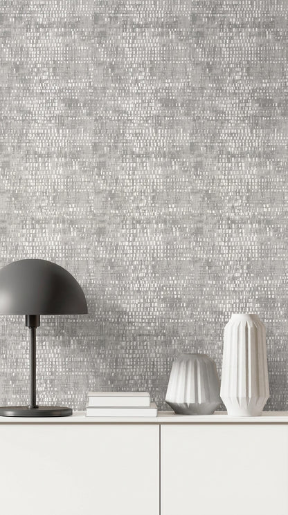 Modern minimalist decor with a black lamp and white books set against gray Dotted Wallpaper.
