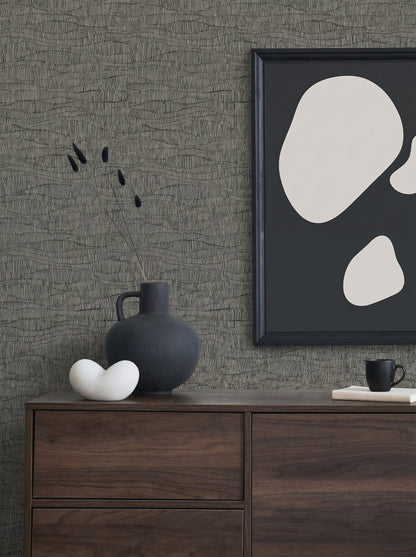 Minimalist decor with a dark vase, abstract art, ceramics on a dresser against Wavy Wallpaper.