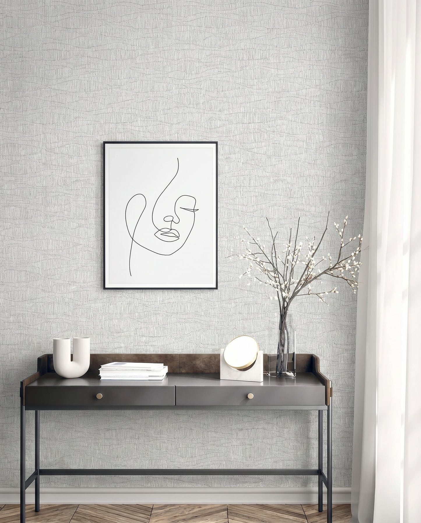 Minimalist desk with vase, books, mirror, and art on a textured wall featuring Wavy Wallpaper (non-woven, washable).
