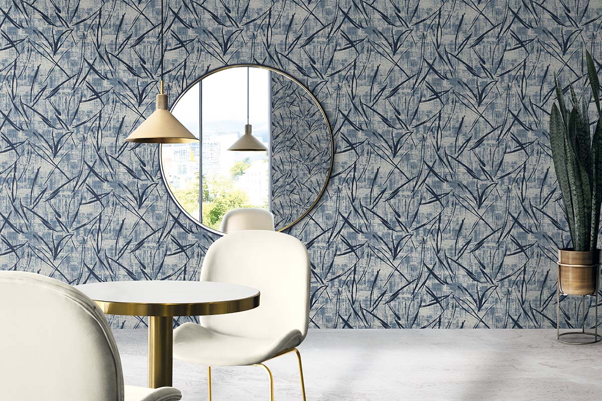 Modern dining with white chairs, round table, Brushstroke Wallpaper, and gold pendant lights.