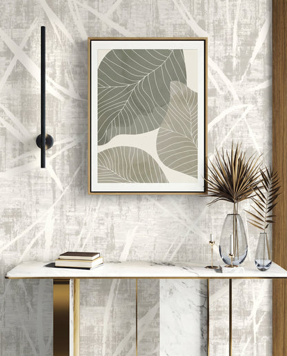 Marble console table with books, glass vases, dried plants, and abstract leaf art on Brushstroke Wallpaper.