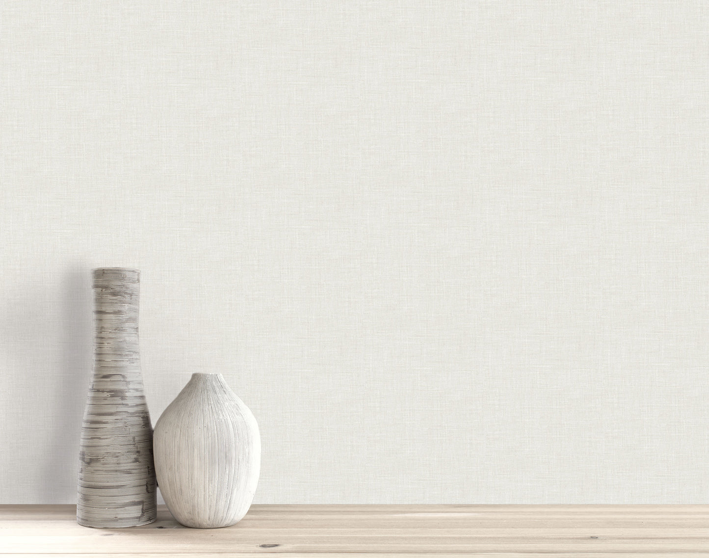 Two vases sit on a wooden surface against a light wall with subtle Faux Linen Wallpaper.