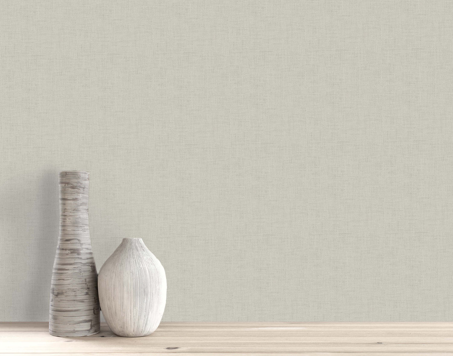 Two decorative vases on a light wooden surface, set against a beige wall with Faux Linen Wallpaper.