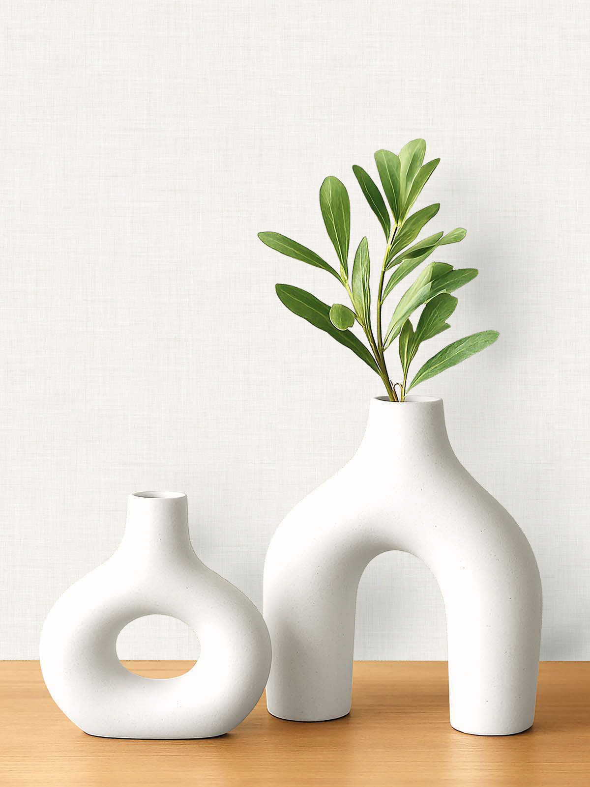 Two white vases on wood; stylish accents for rooms featuring Faux Linen Wallpaper and minimalist decor.