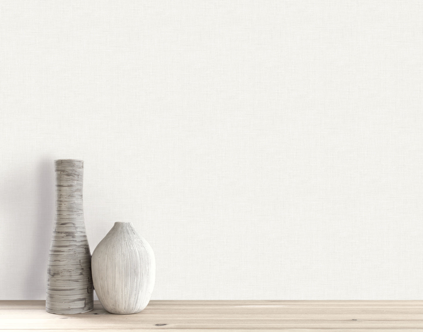 Two decorative vases sit on a wooden surface against a light wall with Faux Linen Wallpaper.
