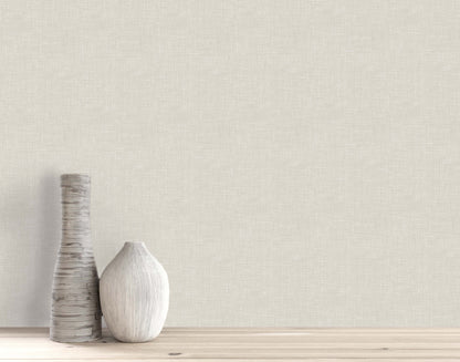 Two decorative vases sit on a wooden surface against a beige wall with Faux Linen Wallpaper.