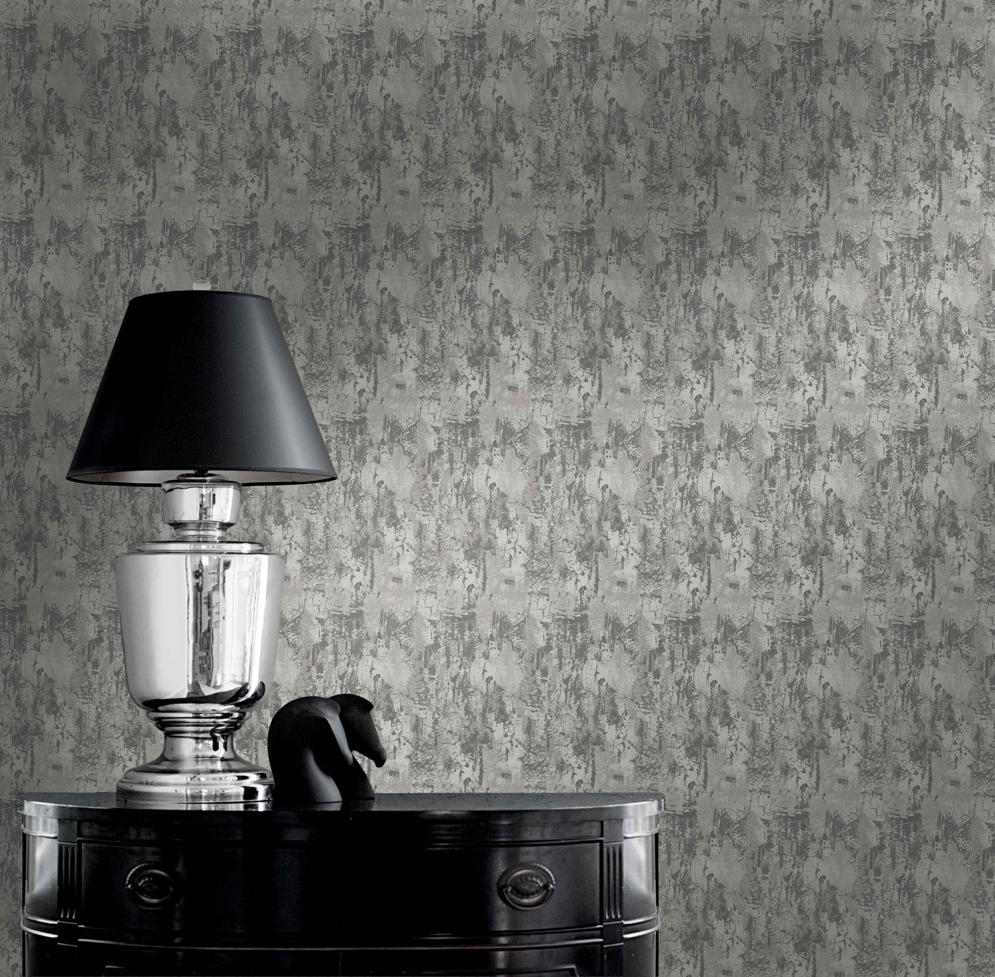 Silver lamp with black shade on glossy table beside sculpture against Faux Concrete Wallpaper.