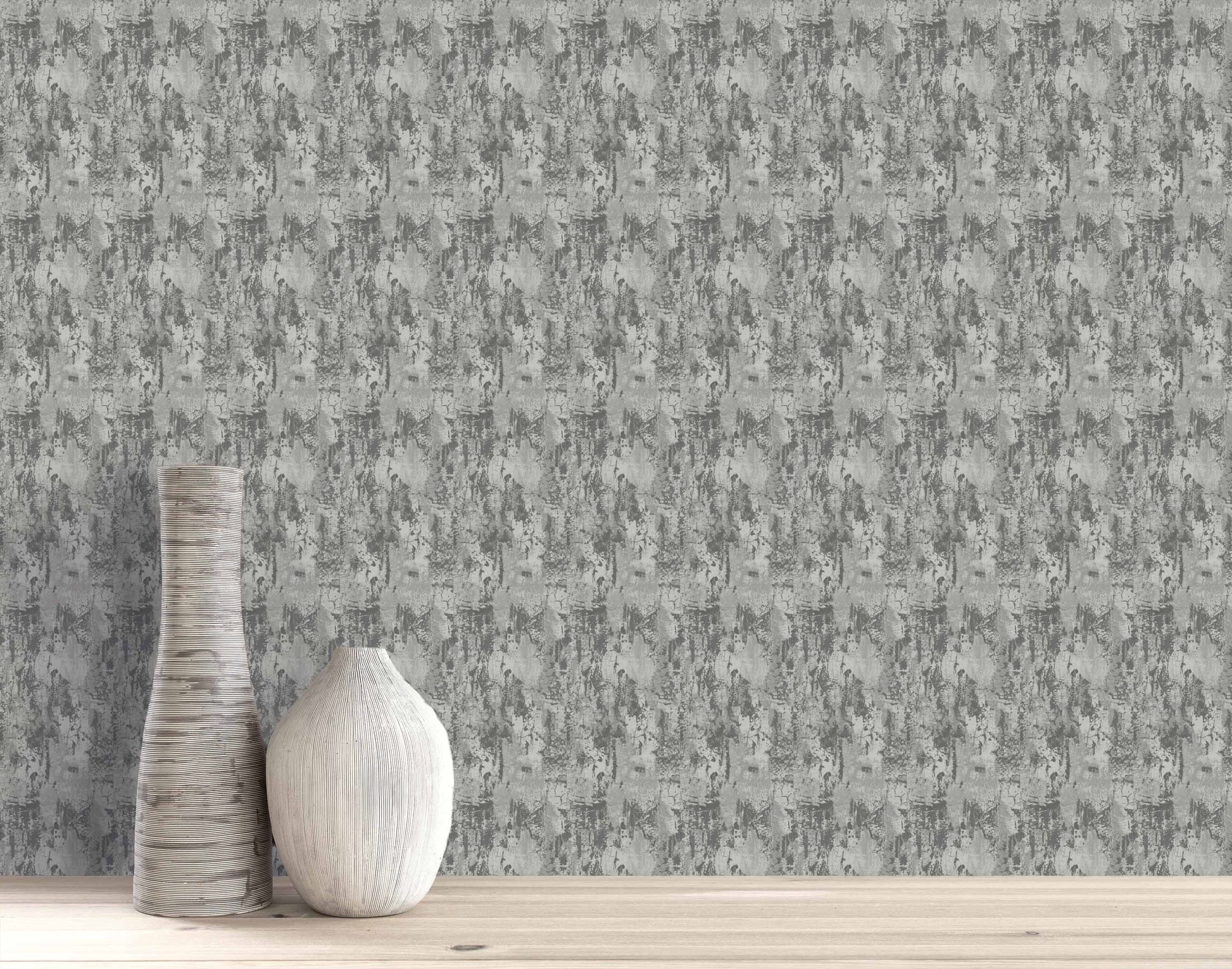 Two textured vases on wood in front of a wall with gray Faux Concrete Wallpaper.
