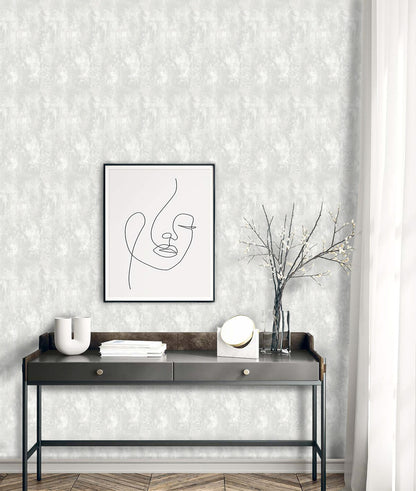 Faux Concrete Wallpaper featured above a sleek black console with decorative objects and books.