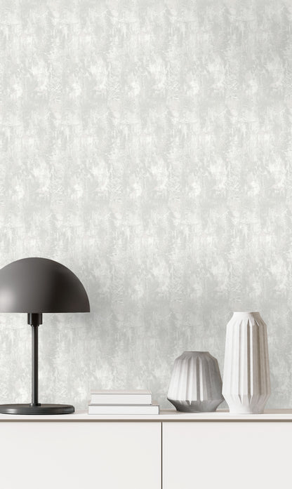 Minimalist decor with a black lamp, white vases, books, and Faux Concrete Wallpaper on a textured white cabinet backdrop.